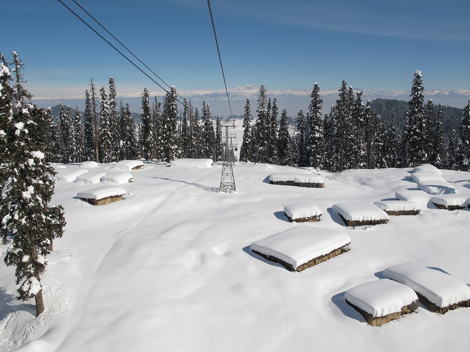 Snow-covered pine forest and mountains seen from the Gulmarg Gondola